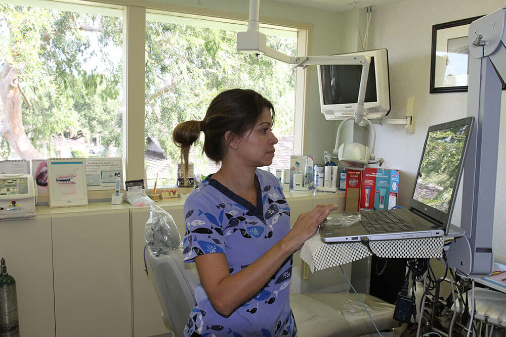 person pointing at their broken tooth