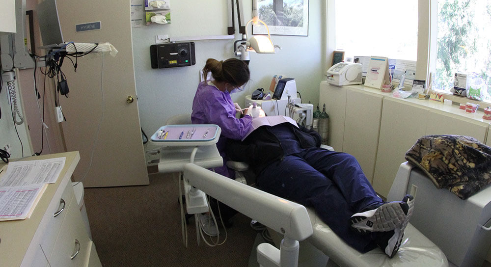 woman pointing at swollen gums