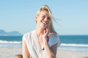 young woman smiling on the beach